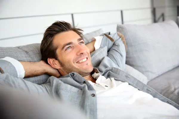 Man relaxing on sofa