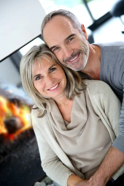 Senior couple enjoying fireplace