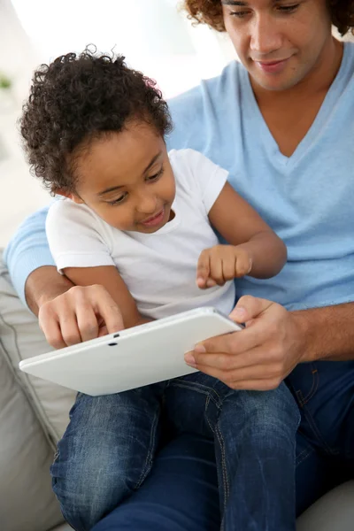 Father and child with tablet