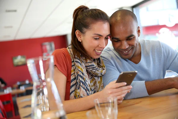 People in coffee shop using smartphones