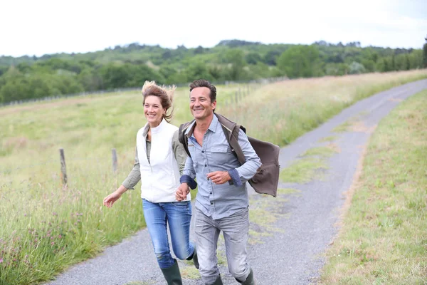 Couple running in countryside