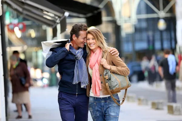 Embracing couple doing shopping