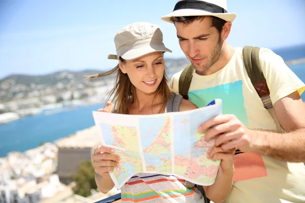Travelers reading map