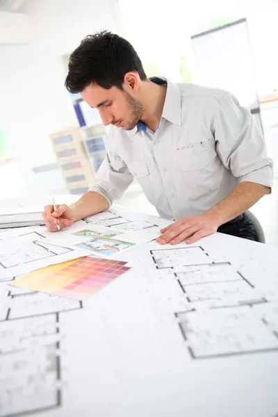 Architect drawing construction blueprint
