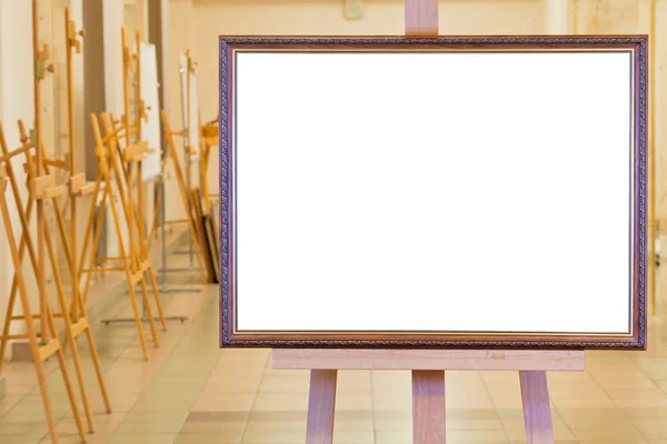 Big picture frame on easel in gallery hall