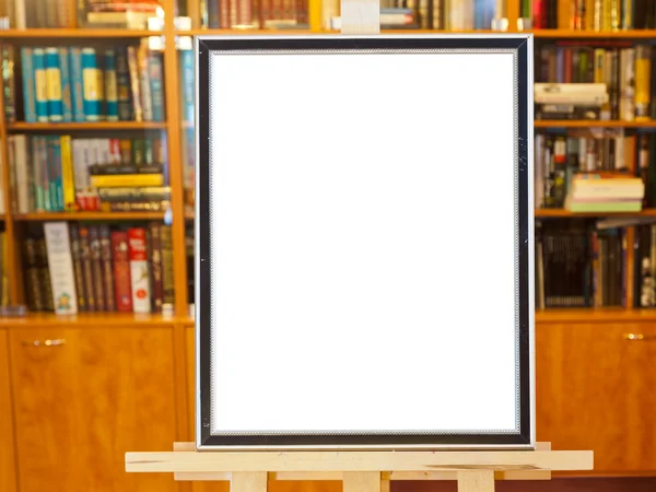 White canvas of picture frame on easel in library