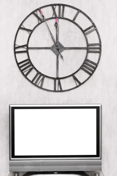 Wall clock under blank white screen of TV