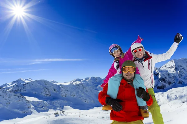 Ski, skier, sun and winter fun - family skiers enjoying winter