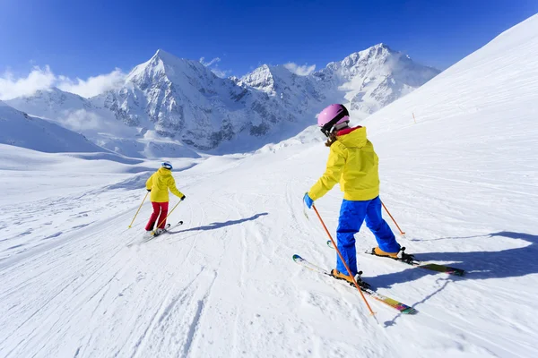 Skiing, skiers on ski run - child skiing downhill, ski lesson