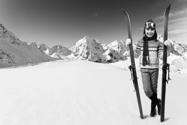 Skiing, winter vacation - girl with retro ski equipment