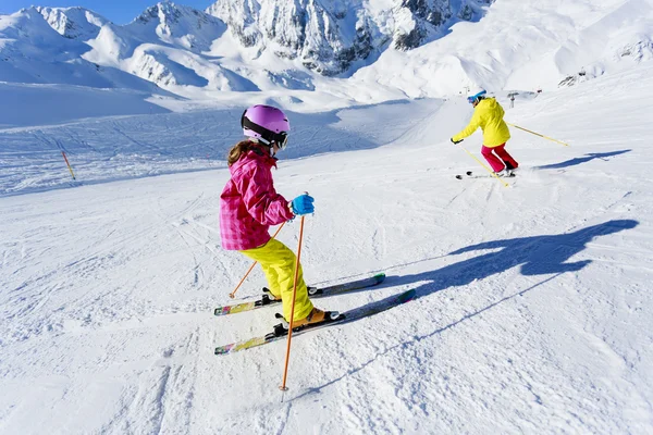 Skiing, skiers on ski run - child skiing downhill, ski lesson