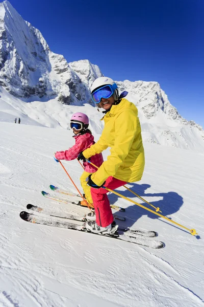 Skiing, skiers on ski run - child skiing downhill, ski lesson