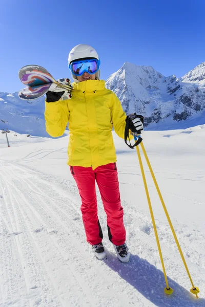 Ski, skier, sun and winter fun - woman enjoying ski vacation