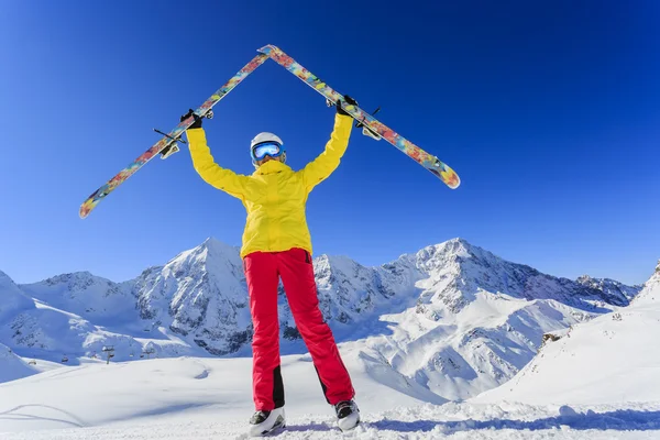 Ski, skier, sun and winter fun - woman enjoying ski vacation