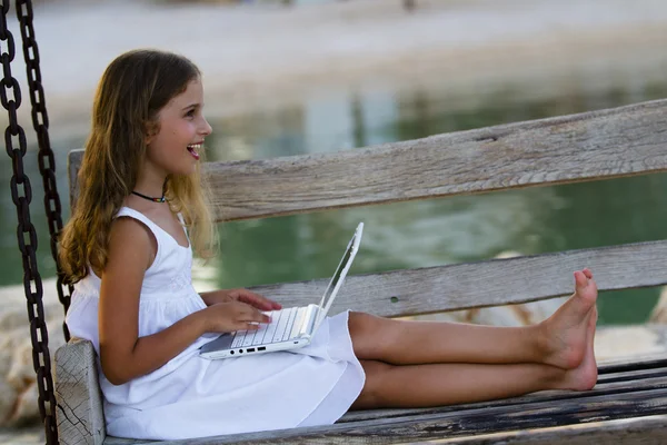 Girl with netbook - young girl with netbook resting on the beach