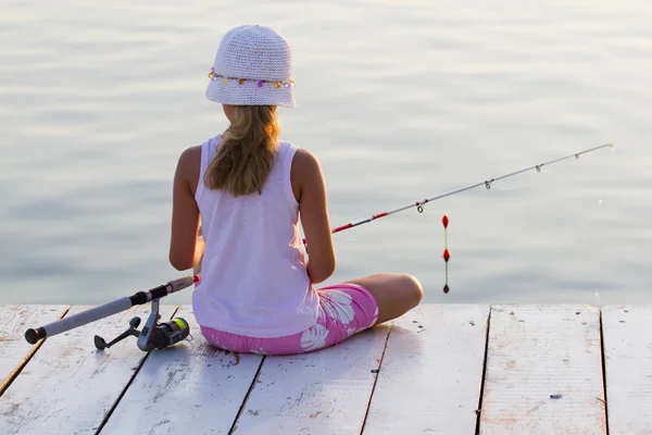 Fishing - lovely girl fishing on the pier