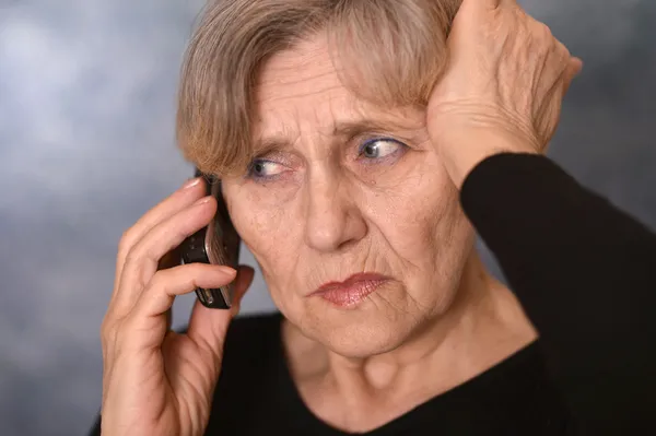 Sad old woman calling