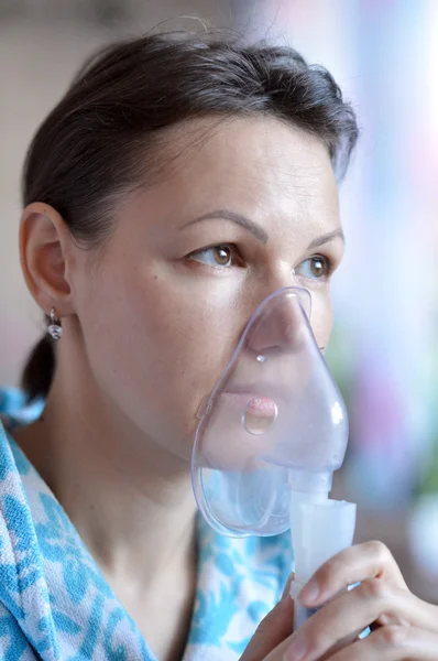 Young woman doing inhalation