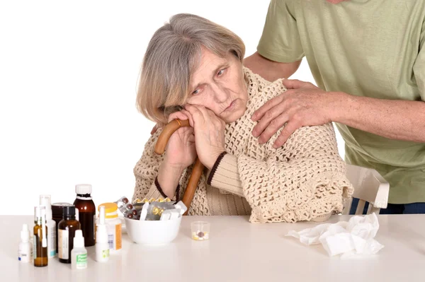 Older man caring for sick woman