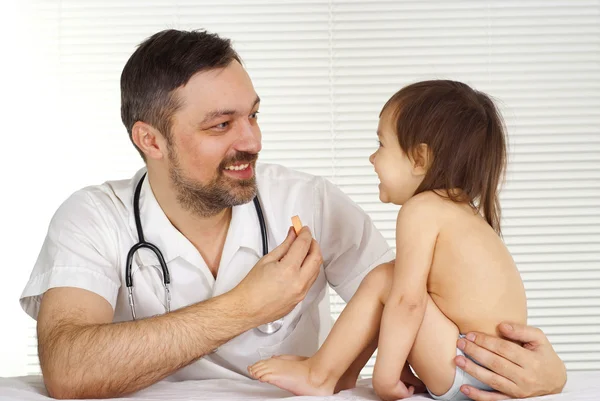 A beautiful caucasian doctor treats a child