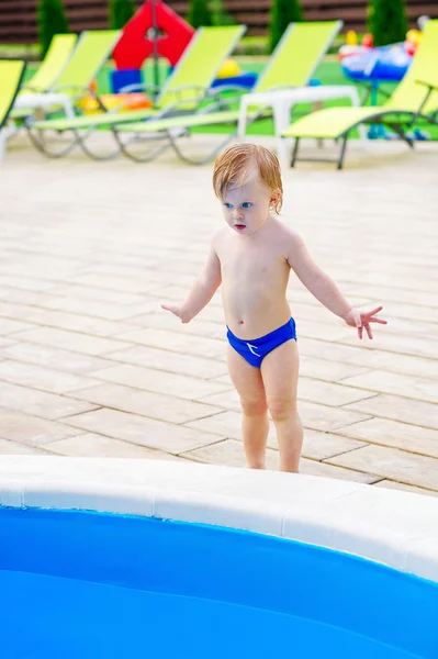 Cute kid by the swimming pool