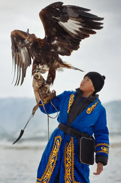 Bird hunter with a golden eagle (Aquila chrysaetos). Kazakhstan.