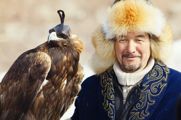 NURA, KAZAKHSTAN - FEBRUARY 23: Eagle on man\'s hand in Nura near