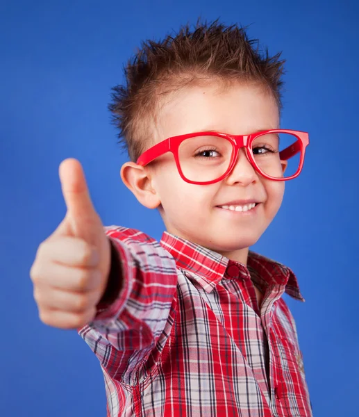 Cheerful five years old boy with thumb up