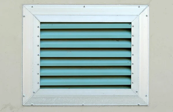 An industrial ventilation fan attached to a building