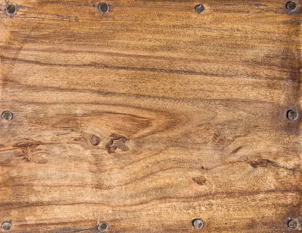 Wooden upper surface of an end table.