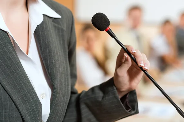 Portrait of a business woman with microphone