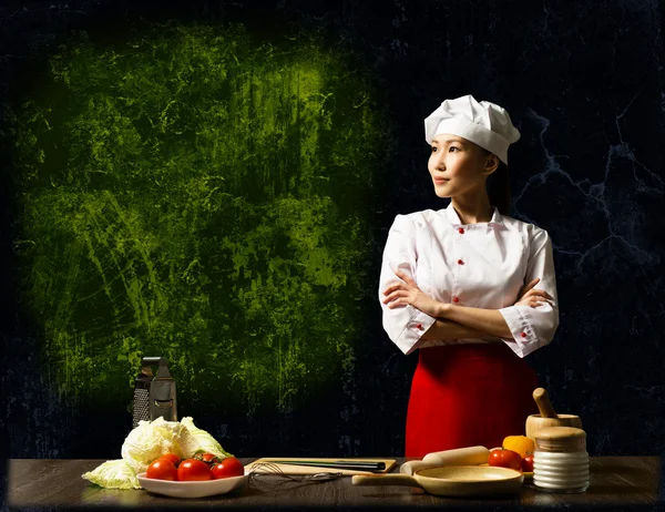 Asian female chef looking at the empty space