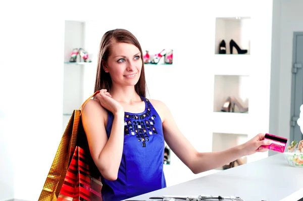 Woman at shopping checkout paying credit card