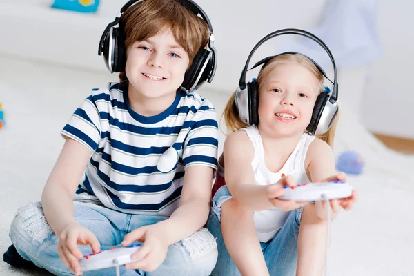 Cute boy and girl playing gaming console