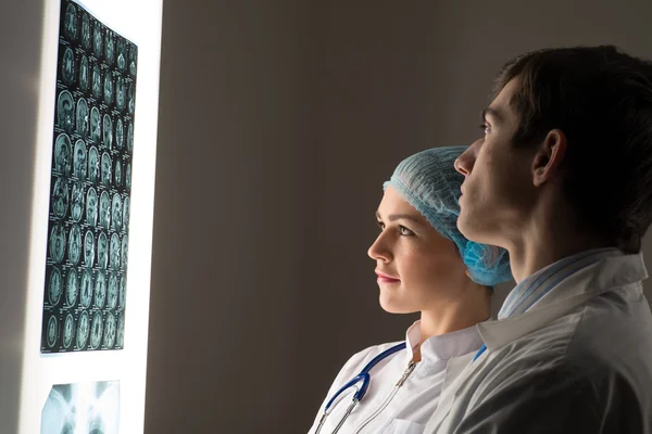 Medical colleagues confer near the x-ray image