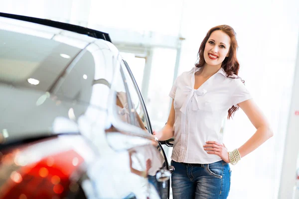 Young woman standing near a car