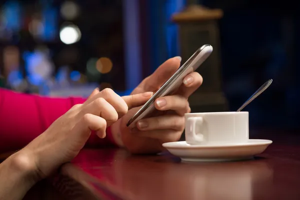 Female hands holding a cell phone