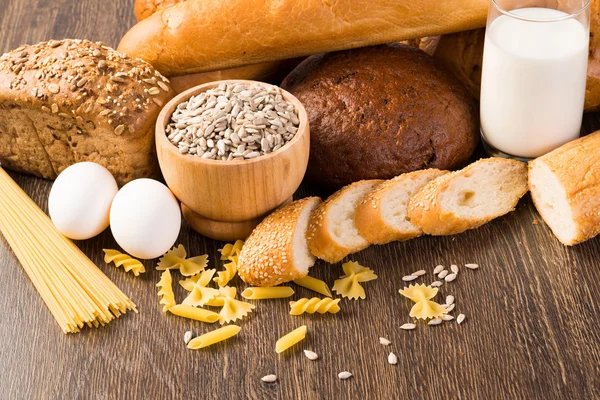 Fresh bread, eggs and glass of milk and grains.