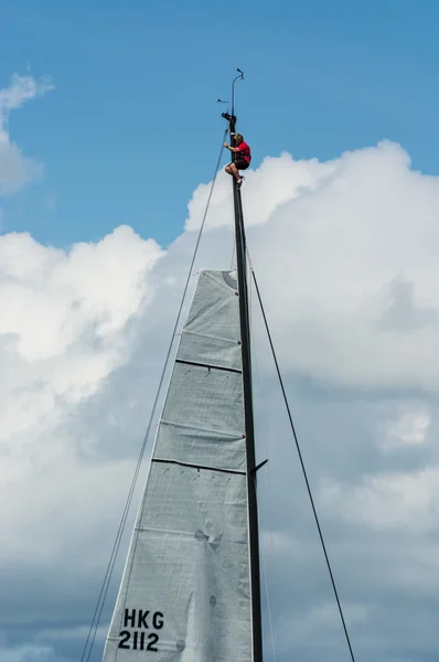 Man on a yacht mast