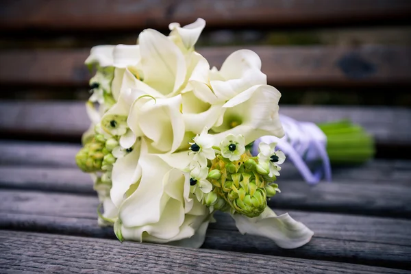 Beautiful wedding flowers bouquet on the dark wooden background