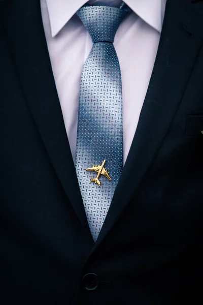 Man\'s jacket and tie with airplane tie-pin