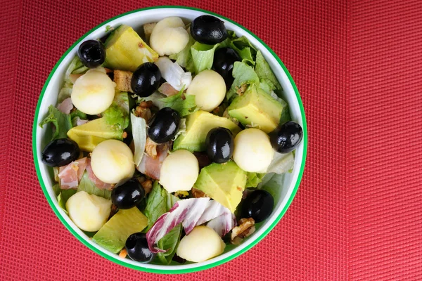 Fresh salad with black olives and avocado