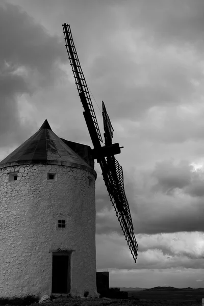 Picture in black and white of an old spanish windmill on a cloudy day