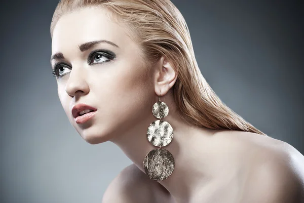 Beautiful woman with earrings. Jewelry and Beauty