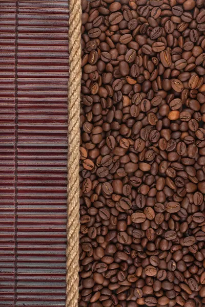 Coffee beans  lying on dark bamboo mat, for menu
