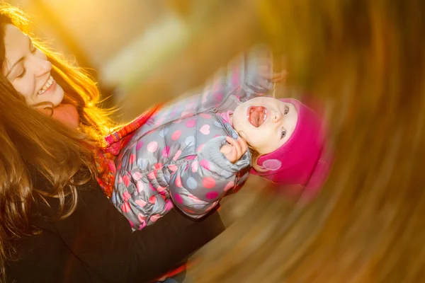 Mother and daughter playing in the park