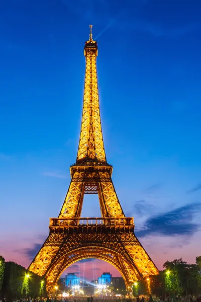 Eiffel Tower brightly illuminated at dusk