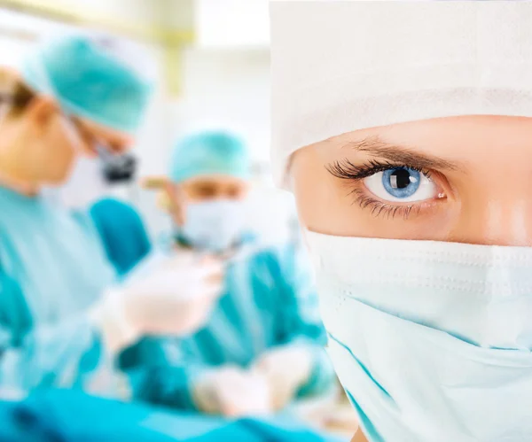 Close-up of a female surgeon with his team