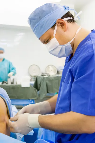 Anesthesiologist performing epidural anesthesia