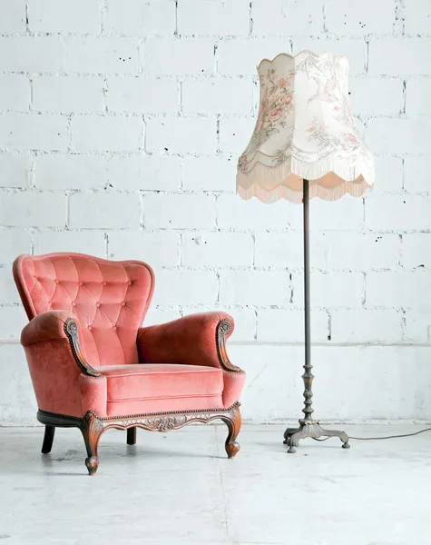 Armchair with desk lamp in vintage room
